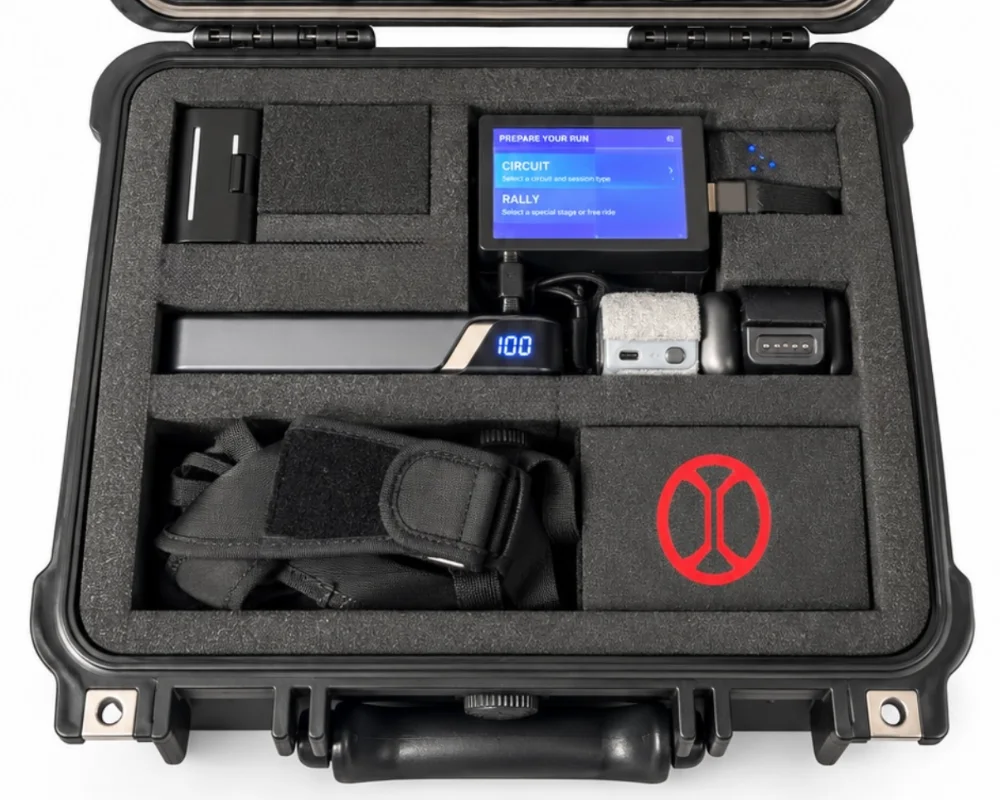 Open black waterproof case with foam inserts: the touchscreen showing Prepare your run, the box with the red SPARK emblem, a battery, straps and small modules.